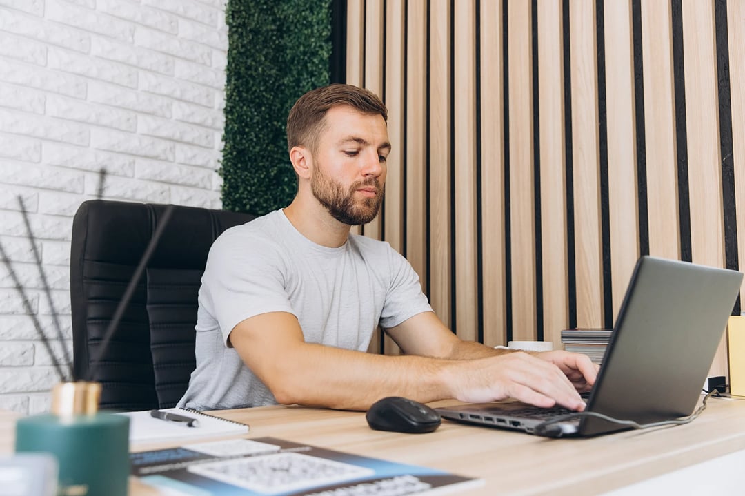 Manager or mechanic writing a report on laptop in car service office