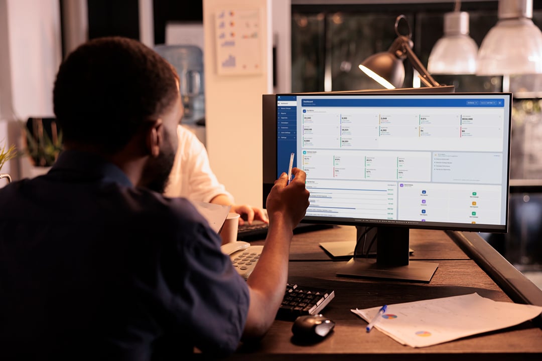 Auto repair shop owner analyzing shop data on computer