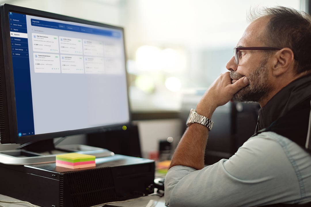 Auto mechanic working on a computer in repair shop office