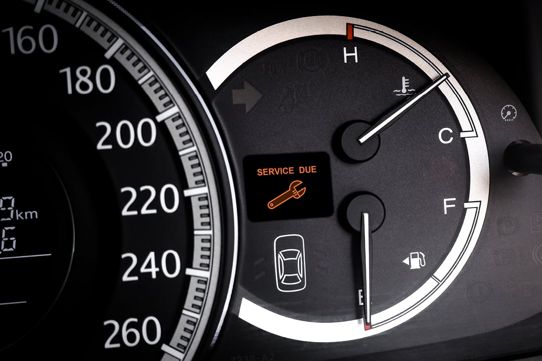 Car dashboard warning light indicating service due