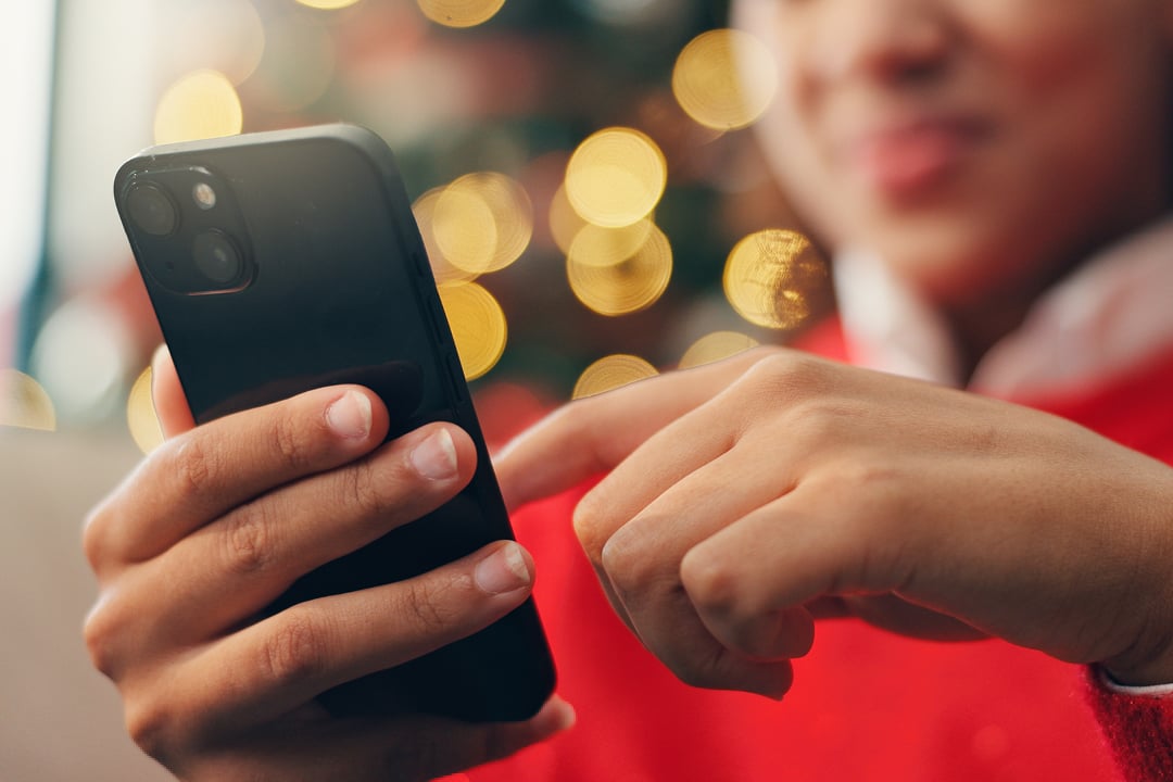 Person using smartphone at home for online shopping