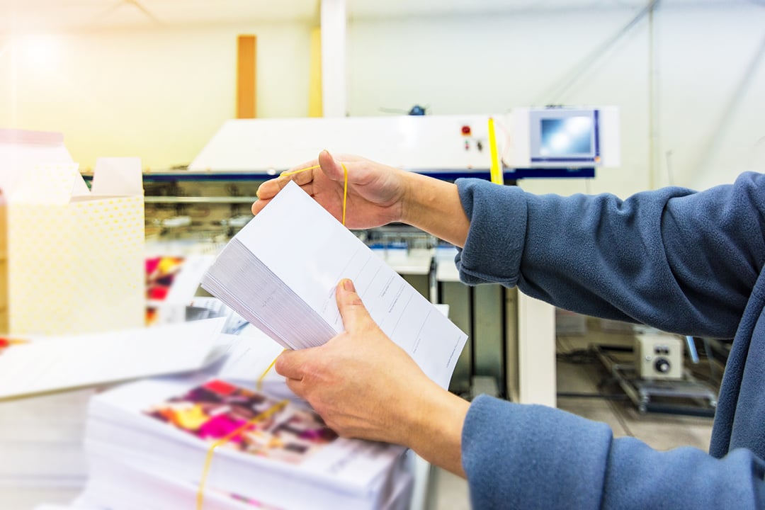 Hands sorting envelopes for mailing
