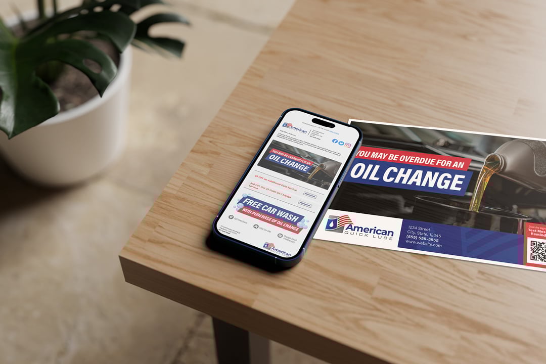 9_Smartphone with email open beside branded postcard on table